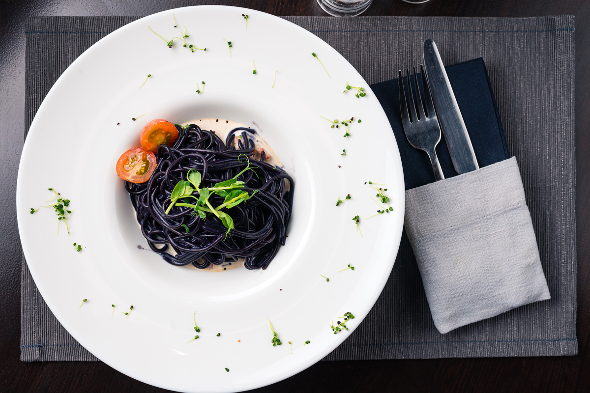 Cuttlefish ink fettuccine with cherry tomatoes
